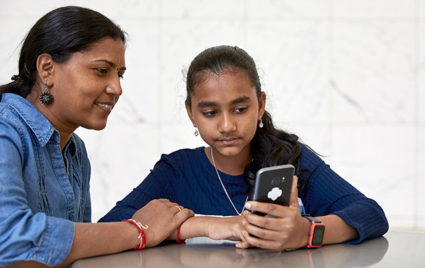 girl scout and parent on phone together