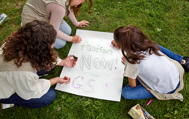 girl scouts creating a poster