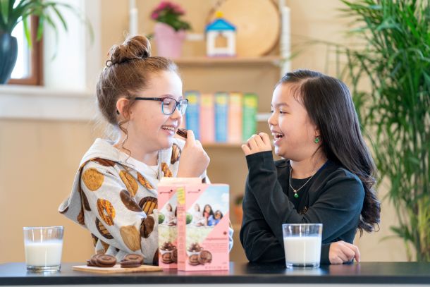 girls enjoying some milk and cookies