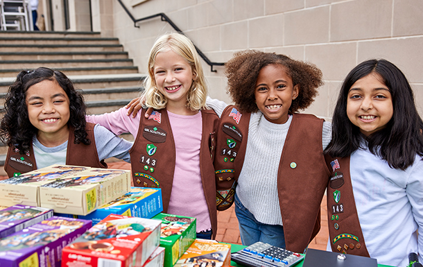 girl scout brownies at their cookie booth