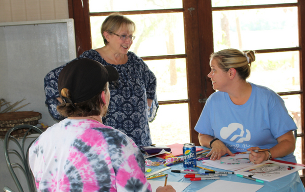 adult volunteers coloring and talking